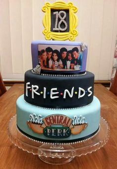 three tiered cake decorated with photos and the words friends