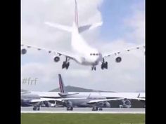 an airplane is taking off from the runway with it's landing gear down and another plane in the background