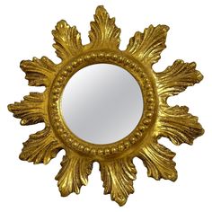 an ornate gold mirror is shown against a white background