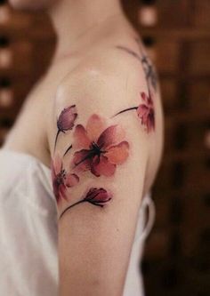 a woman's arm with flowers painted on it