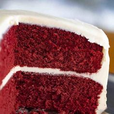 a slice of red velvet cake with white frosting