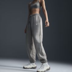 Find NIKE Sportswear Phoenix Fleece High-waisted Oversized Sweatpants on Editorialist. Grounded in style, comfort and versatility, meet our take on luxury loungewear. Whether you're running errands or rewatching your favorite show, these midweight fleece sweats feel extra soft on the inside to help keep you cozy. The oversized fit is intended to sit high on your hips for comfort and a stay-put feel. Benefits:Encased elastic waistband and drawstrings ensure a fit that feels just right. Pockets pr Nike Comfortable Sweats With Elastic Waistband, Comfortable Nike Sweats With Elastic Waistband, Sportswear Sweatpants With Elastic Waistband For Fall, Athleisure Sweatpants With Elastic Waistband For Streetwear, Fall Season Sportswear Sweatpants, Fall Sweatpants With Elastic Waistband, Nike Fleece Sweats With Elastic Waistband, Comfortable Nike Sweatpants, Nike Comfortable Sweatpants With Elastic Waistband