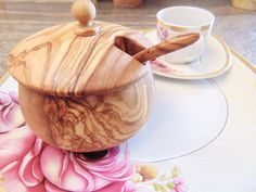 a wooden pot and saucer sitting on top of a table