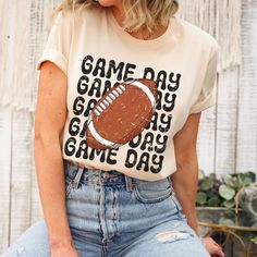 a woman wearing a game day t - shirt with a football on it