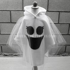 a white ghost head with black eyes on it's face and veil over his head