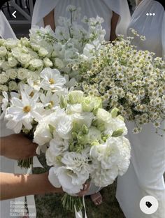 the bridesmaids are holding bouquets of white flowers