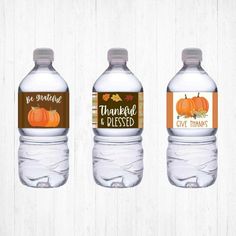 three water bottles with thanksgiving labels on them