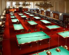 a large room filled with lots of pool tables