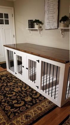 a dog kennel in the middle of a room with a rug on the floor