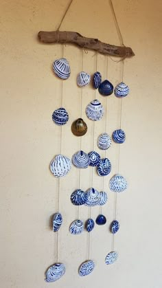 a wind chime with blue and white shells hanging from it