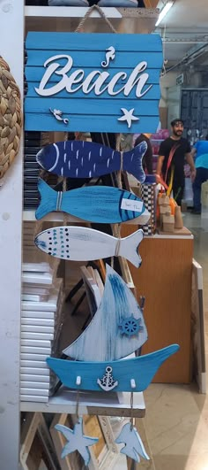 a sign that says beach hanging from the side of a building in front of other signs