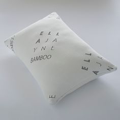 a white pillow with black writing on it