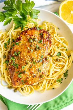 a white bowl filled with pasta and meat topped with parmesan sprinkles