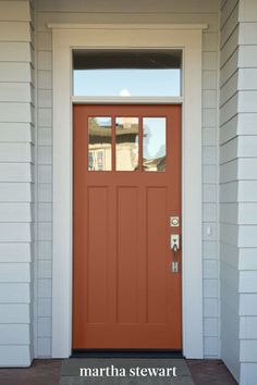 a red front door with two sidelights and a window on the top half of it