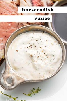 there is a bowl of horseradish sauce next to some meat on the plate