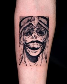 a man's leg with a tattoo on it that has an image of a joker