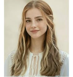 a woman with long hair wearing a white blouse