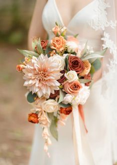 a bridal holding a bouquet of flowers