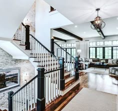 a living room filled with furniture and a staircase