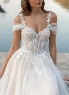 a woman in a wedding dress is posing for the camera with her hands on her hips