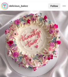 a birthday cake decorated with flowers and the words happy new year written in frosting