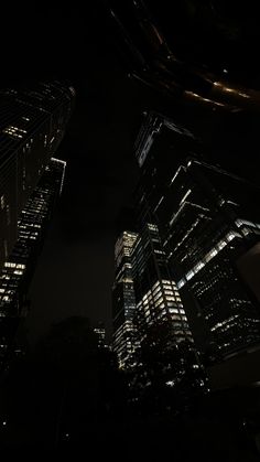 some very tall buildings lit up at night