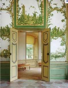 an open door leading into a room with wallpaper and paintings on the walls,