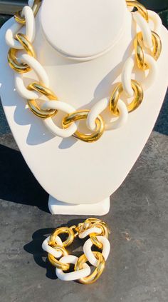 "Givenchy Statement Jewelry Set Matching Necklace and Bracelet Large Gold and White Chain Link Runway Vintage Paris Designer Both pieces signed Givenchy on the back Alternating gold tone metal and white plastic chunky oversized chain links Fold over clasps are both in perfect working order, minimal to no wear on both pieces The necklace measures 17.5\" end to end and 1\" wide The bracelet measures 8.25\" end to end and 1\" wide Both items have links that get slightly larger towards the center an White Link Chain Bracelets, White Link Necklace With Gold Chain, White Chain Link Jewelry, White Gold Chain Link Jewelry, White Link Metal Jewelry, White Link Chain Metal Necklace, White Metal Link Chain Necklace, White Chunky Link Chain Necklaces, Matching Necklace And Bracelet