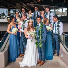 a group of people standing next to each other in front of a building with flowers