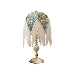 a table lamp with tassels and beads on it's sides, sitting on a white surface