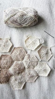 two skeins of yarn sitting on top of a table next to each other