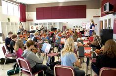 a group of people playing instruments in a room