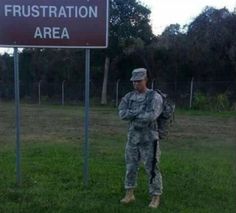 a soldier standing in front of a sign that says frustration area