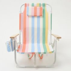 a multicolored beach chair sitting on top of a white table