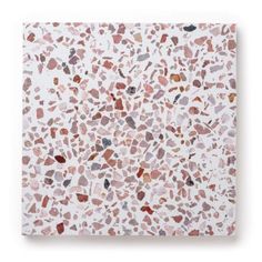 a white tile with red and brown speckles on it's surface, against a white background