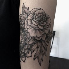 a woman's arm with flowers on it and an instagramt for the photo