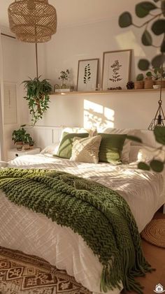 a bed with green and white blankets on top of it