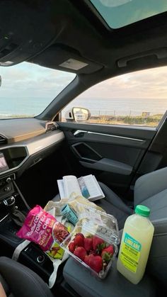 the back seat of a car filled with food and drinks