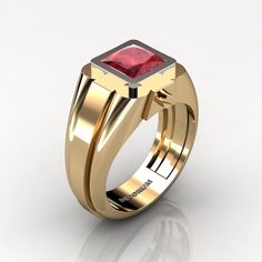 a gold ring with a red stone in the center