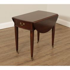 a small wooden table sitting on top of a hard wood floor