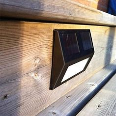 a wooden bench with a solar powered light on it