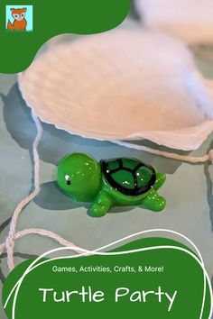 a green turtle toy sitting on top of a table