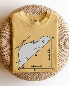 a yellow t - shirt with an image of a narwhale on it