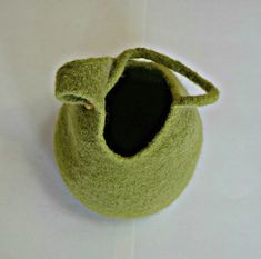 a small green bag sitting on top of a white table