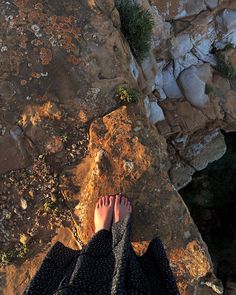 a person standing on top of a rocky cliff