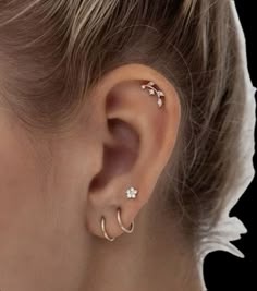 a close up of a person with ear piercings