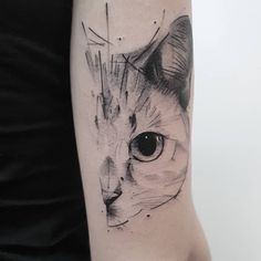 a cat's face is shown in black and grey ink on the right arm