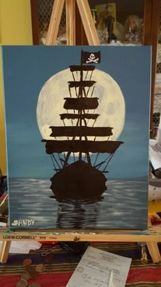 an easel with a painting of a pirate ship on it