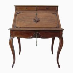 an old wooden desk with drawers on the top and one drawer open to reveal a keyhole