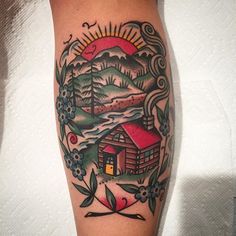 a person with a tattoo on their arm and the image of a cabin in the background